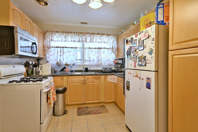 kitchen featuring white appliances, light brown cabinets, light tile patterned floors, and dark countertops