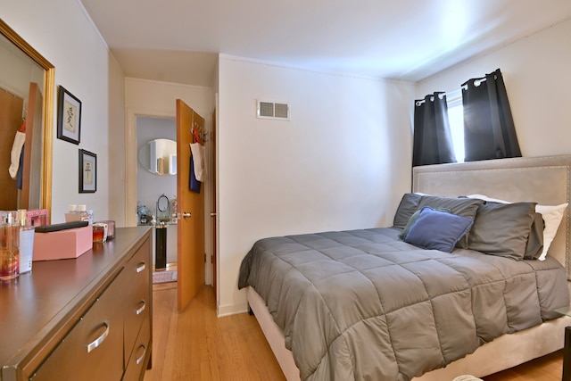 bedroom featuring light wood-style flooring
