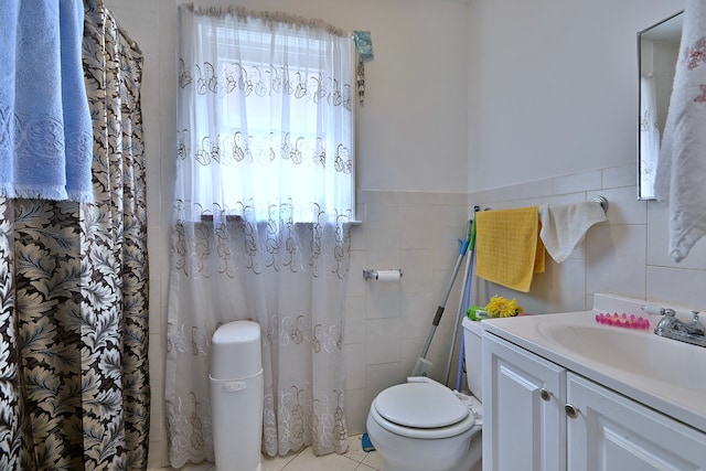 bathroom with vanity, tile walls, and tile patterned flooring