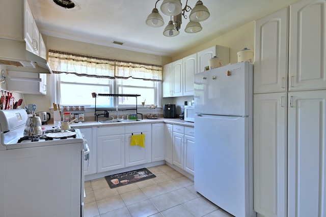 kitchen featuring white appliances, a chandelier, white cabinetry, light tile patterned floors, and premium range hood