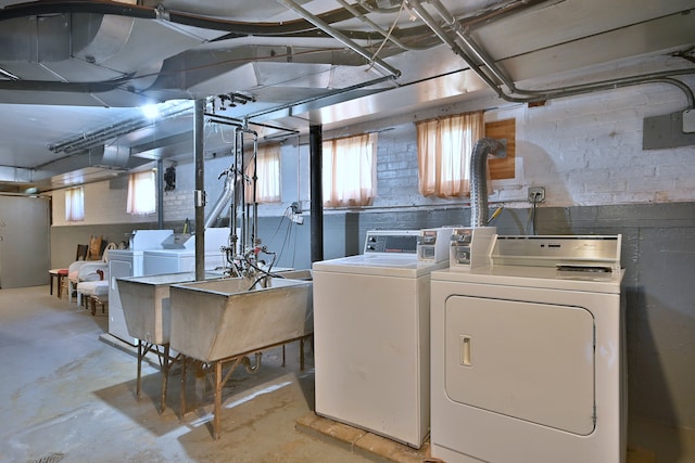 basement featuring washer and clothes dryer and a sink