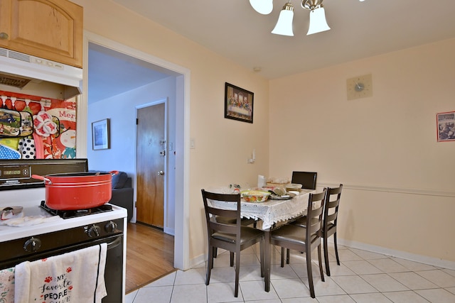 dining room with baseboards and light tile patterned floors
