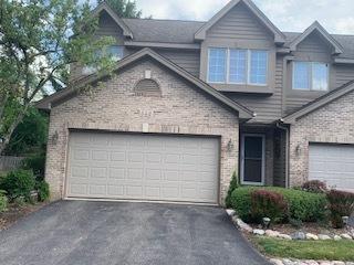 542 Silver Aspen Cir, Crystal Lake, IL 60014 - view of front facade with driveway, an attached garage, and brick siding