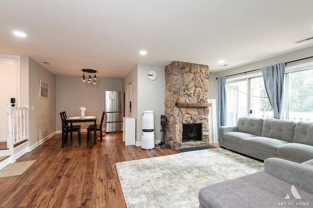 257 Coventry Cir Unit 136, Vernon Hills, IL 60061 - living room featuring dark wood-style floors, recessed lighting, a stone fireplace, and a chandelier