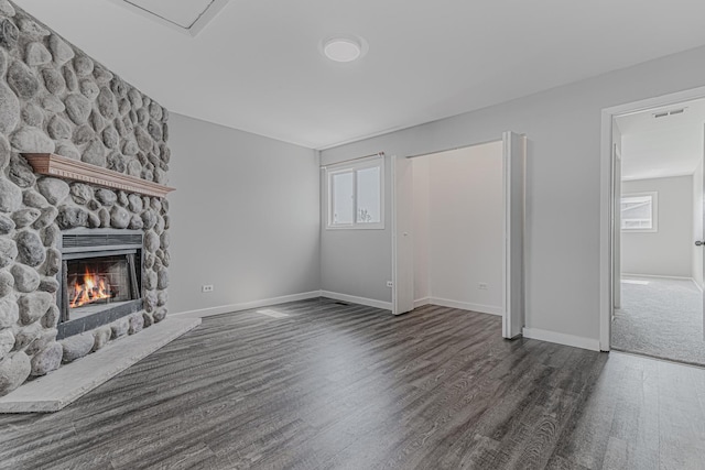 17357 W Maple Ln, Gurnee, IL 60031 - unfurnished living room with a stone fireplace and dark wood-style floors