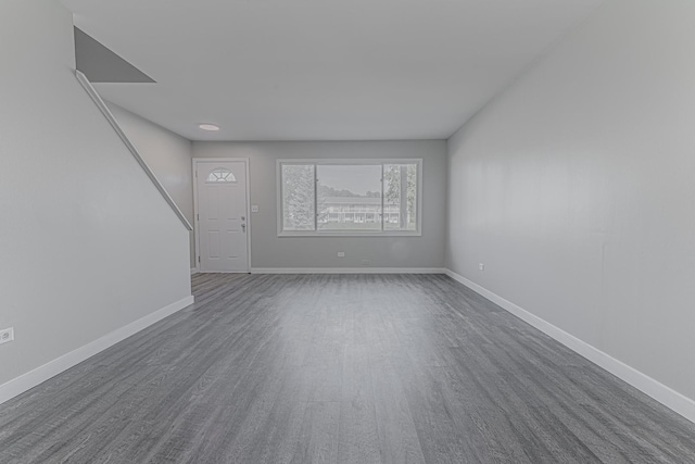 17357 W Maple Ln, Gurnee, IL 60031 - unfurnished living room featuring dark wood-style floors and stairs