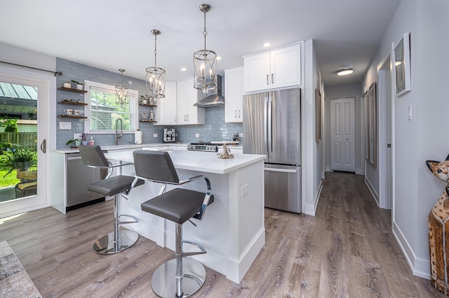 1815 Evergreen Ave, Hanover Park, IL 60133 - kitchen featuring stainless steel appliances, open shelves, wall chimney range hood, light countertops, and white cabinets