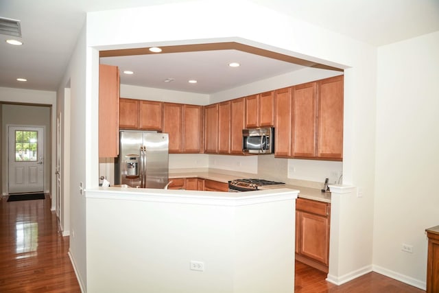 13445 Meadowlark Ln, Huntley, IL 60142 - kitchen with appliances with stainless steel finishes, wood finished floors, a peninsula, recessed lighting, and light countertops