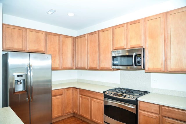 13445 Meadowlark Ln, Huntley, IL 60142 - kitchen featuring appliances with stainless steel finishes, light countertops, recessed lighting, and wood finished floors