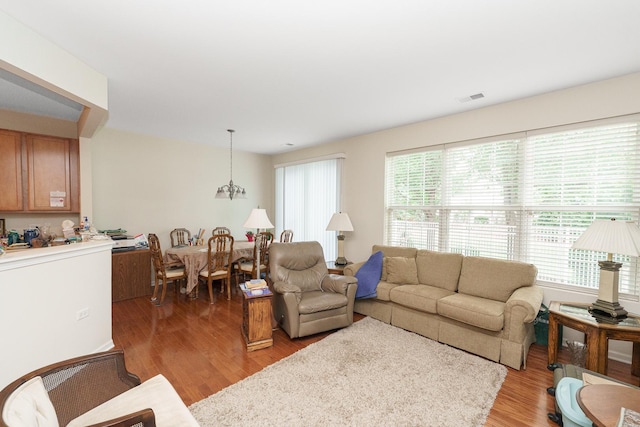 13445 Meadowlark Ln, Huntley, IL 60142 - living area featuring light wood-style floors, healthy amount of natural light, and a chandelier