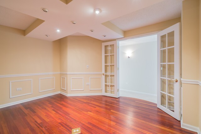470 Fawell Blvd Unit 411, Glen Ellyn, IL 60137 - spare room featuring french doors, wood finished floors, and a wainscoted wall