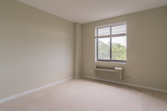 470 Fawell Blvd Unit 411, Glen Ellyn, IL 60137 - spare room with a wall mounted air conditioner, light colored carpet, and a textured ceiling