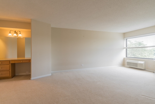470 Fawell Blvd Unit 411, Glen Ellyn, IL 60137 - unfurnished bedroom featuring a wall mounted AC, light colored carpet, a textured ceiling, built in desk, and a chandelier