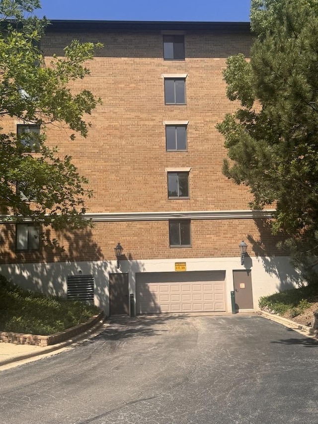 470 Fawell Blvd Unit 411, Glen Ellyn, IL 60137 - view of building exterior with a garage and asphalt driveway
