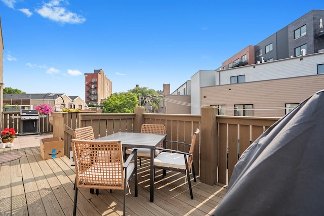 1225 N Paulina St Unit 3S, Chicago, IL 60622 - wooden deck with a grill, outdoor dining space, and a residential view
