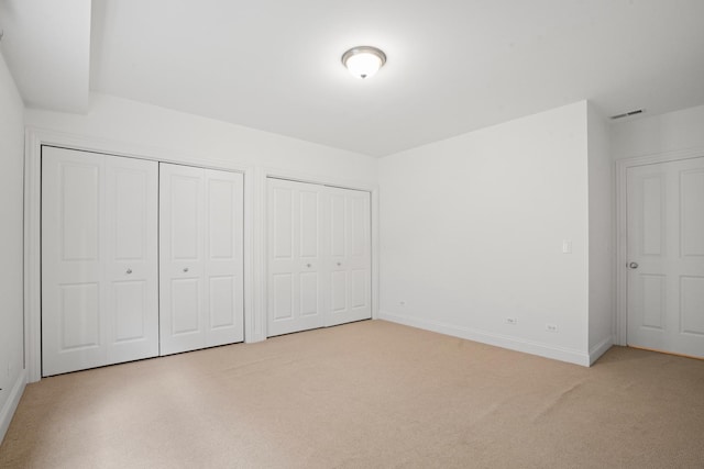 1225 N Paulina St Unit 3S, Chicago, IL 60622 - unfurnished bedroom featuring multiple closets and light carpet