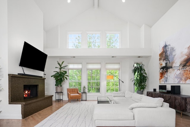 1225 N Paulina St Unit 3S, Chicago, IL 60622 - living area with high vaulted ceiling, a fireplace, wood finished floors, and beam ceiling