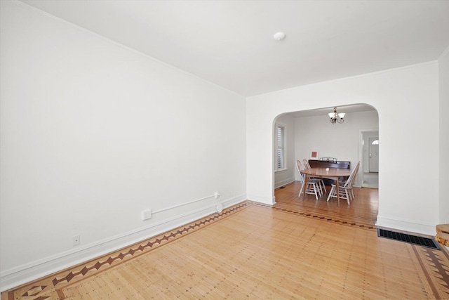 1629 W Foster Ave, Chicago, IL 60640 - unfurnished room featuring arched walkways, a chandelier, crown molding, and light flooring