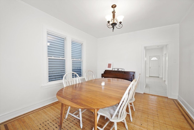 1629 W Foster Ave, Chicago, IL 60640 - dining space with a chandelier, light wood-style flooring, and ornamental molding