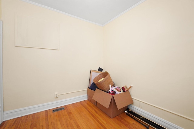 1629 W Foster Ave, Chicago, IL 60640 - spare room with crown molding and wood finished floors