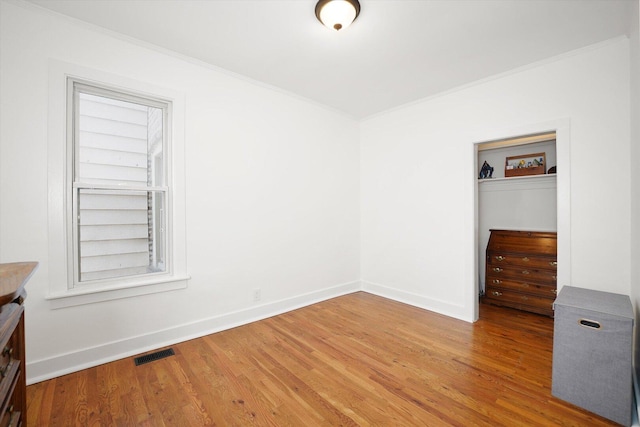 1629 W Foster Ave, Chicago, IL 60640 - unfurnished bedroom with crown molding and light wood finished floors