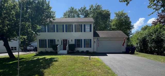 36872 N Lawrence Dr, Lake Villa, IL 60046 - colonial home featuring a garage, asphalt driveway, a front lawn, and entry steps