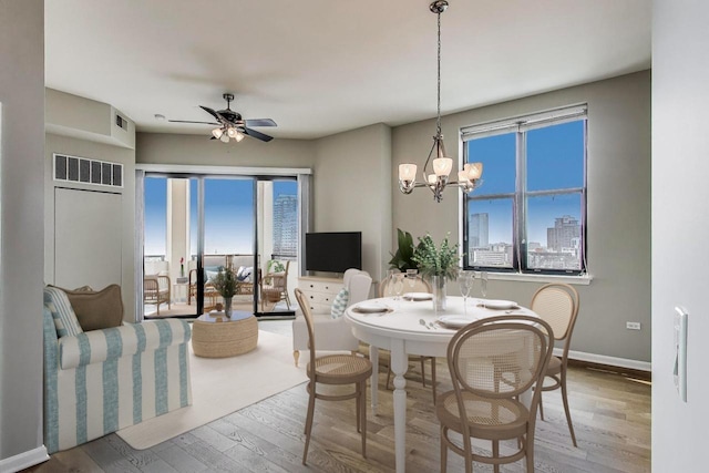 1464 S Michigan Ave Unit 1404, Chicago, IL 60605 - dining room with wood finished floors, a chandelier, ceiling fan, and plenty of natural light