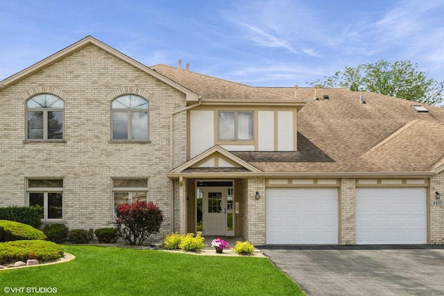 6433 Pine Cone Dr Unit 1, Tinley Park, IL 60477 - view of front of home with a shingled roof, driveway, a front yard, and brick siding