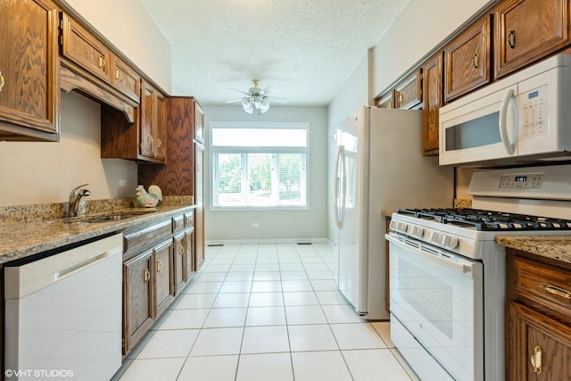 6433 Pine Cone Dr Unit 1, Tinley Park, IL 60477 - kitchen with white appliances, ceiling fan, a textured ceiling, light stone countertops, and brown cabinetry