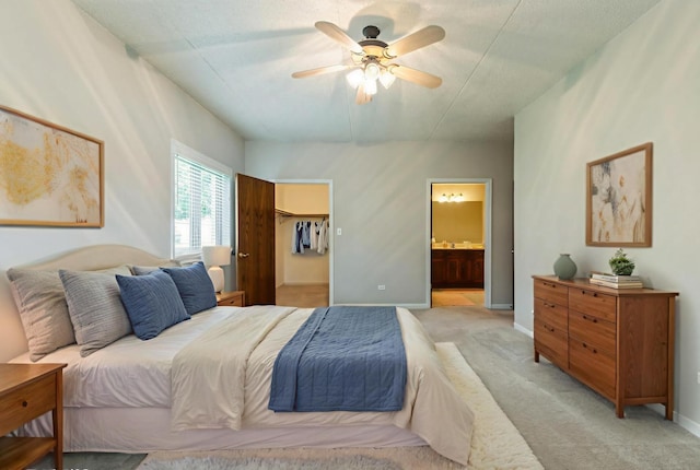 6433 Pine Cone Dr Unit 1, Tinley Park, IL 60477 - bedroom featuring light carpet, connected bathroom, a walk in closet, and a ceiling fan
