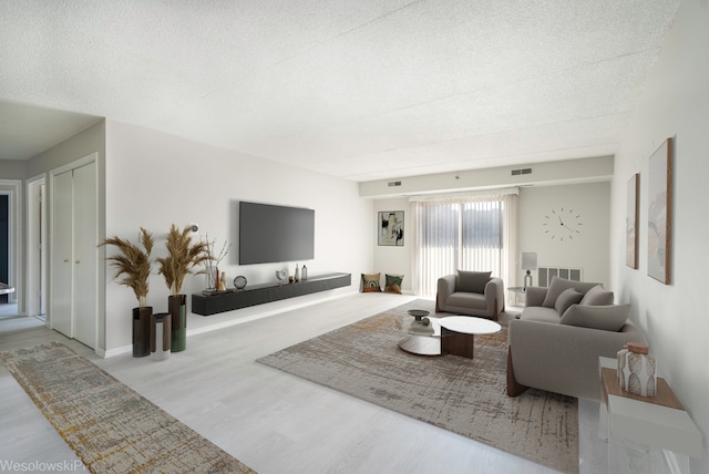 6211 Lincoln Ave Unit 402, Morton Grove, IL 60053 - living area featuring wood finished floors and a textured ceiling
