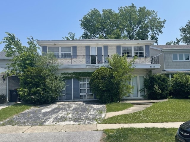 6851 N Lockwood Ave, Skokie, IL 60077 - view of front of property with a balcony, driveway, and brick siding