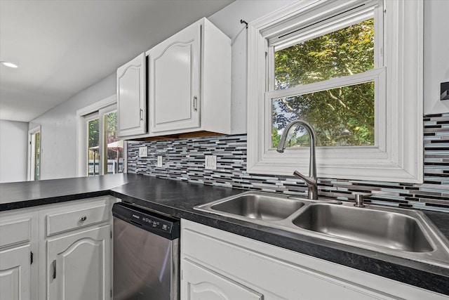 410 N 4th St, Saint Joseph, IL 61873 - kitchen featuring stainless steel dishwasher, dark countertops, tasteful backsplash, white cabinets, and healthy amount of natural light
