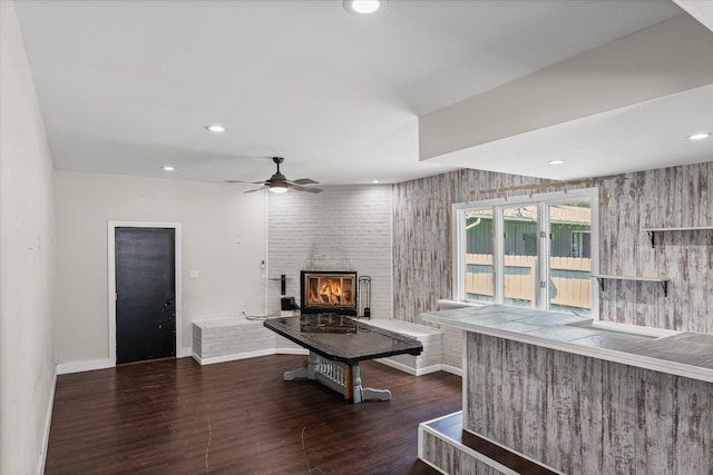 410 N 4th St, Saint Joseph, IL 61873 - living area with dark wood-style flooring, a brick fireplace, a ceiling fan, and recessed lighting