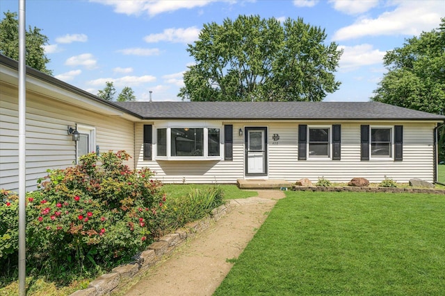 410 N 4th St, Saint Joseph, IL 61873 - ranch-style home featuring a front yard and roof with shingles