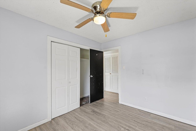 410 N 4th St, Saint Joseph, IL 61873 - unfurnished bedroom featuring light wood-style floors, a closet, and ceiling fan