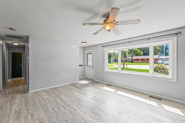 410 N 4th St, Saint Joseph, IL 61873 - unfurnished living room featuring light wood-style flooring and a ceiling fan