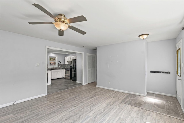 410 N 4th St, Saint Joseph, IL 61873 - unfurnished living room featuring a ceiling fan and wood finished floors