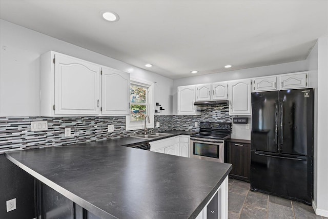 410 N 4th St, Saint Joseph, IL 61873 - kitchen featuring freestanding refrigerator, stainless steel range with electric stovetop, dark countertops, a peninsula, and white cabinets