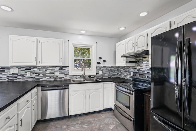410 N 4th St, Saint Joseph, IL 61873 - kitchen featuring appliances with stainless steel finishes, dark countertops, under cabinet range hood, white cabinetry, and tasteful backsplash