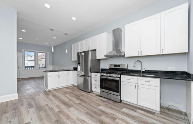 4329 S Wood St, Chicago, IL 60609 - kitchen with wall chimney range hood, stainless steel appliances, light wood finished floors, recessed lighting, and white cabinets