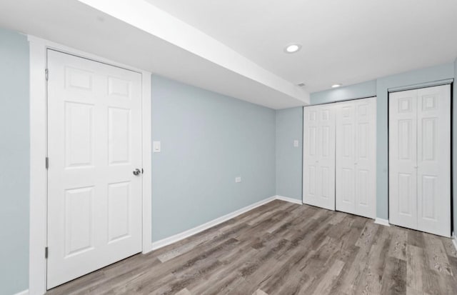 4329 S Wood St, Chicago, IL 60609 - unfurnished bedroom with wood finished floors, two closets, and recessed lighting