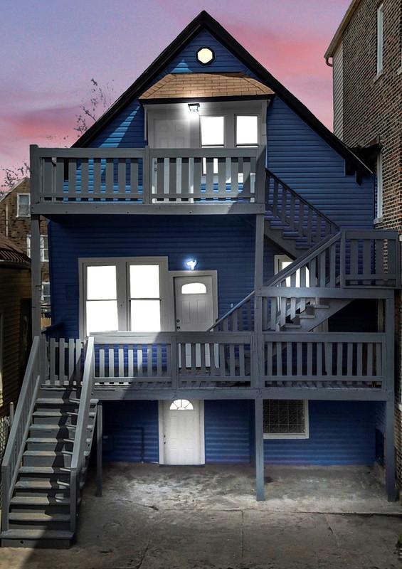 4329 S Wood St, Chicago, IL 60609 - back of property at dusk featuring stairs and a balcony