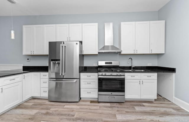 4329 S Wood St, Chicago, IL 60609 - kitchen with appliances with stainless steel finishes, wall chimney range hood, light wood finished floors, hanging light fixtures, and white cabinetry
