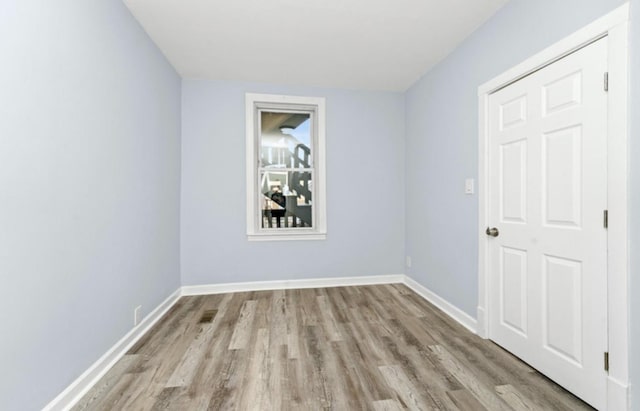 4329 S Wood St, Chicago, IL 60609 - empty room featuring wood finished floors and baseboards