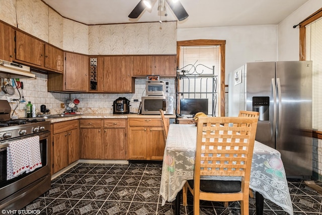 4330 S Talman Ave, Chicago, IL 60632 - kitchen featuring stainless steel appliances, light countertops, a ceiling fan, tasteful backsplash, and brown cabinetry