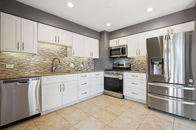 492 Winthrop Ave, Glendale Heights, IL 60139 - kitchen with appliances with stainless steel finishes, stone counters, white cabinets, light tile patterned flooring, and recessed lighting