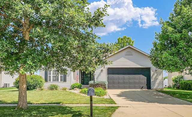 4006 Tallgrass Dr, Champaign, IL 61822 - view of property hidden behind natural elements featuring a front yard, an attached garage, and concrete driveway