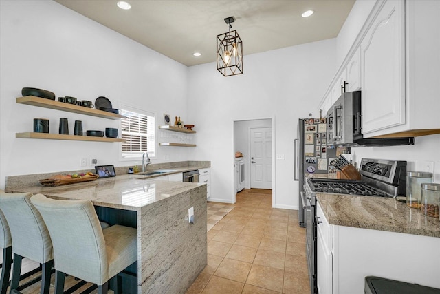 4006 Tallgrass Dr, Champaign, IL 61822 - kitchen with stainless steel appliances, open shelves, a peninsula, white cabinetry, and light stone countertops