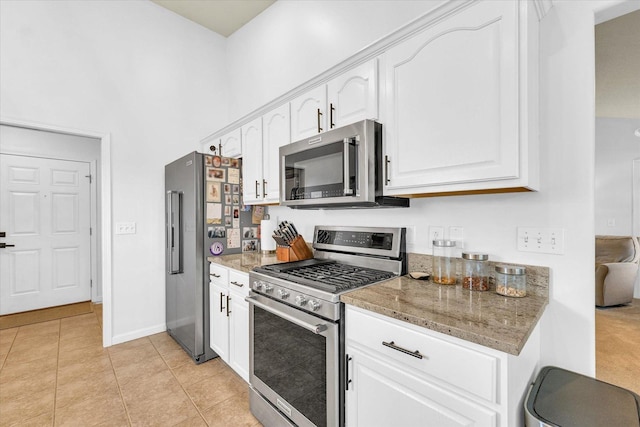 4006 Tallgrass Dr, Champaign, IL 61822 - kitchen with appliances with stainless steel finishes, white cabinets, light stone counters, and a towering ceiling